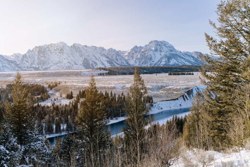 Scenic view of Grand Teton National Park in Wyoming with mountains, river, and snowy landscape, ideal for elopements