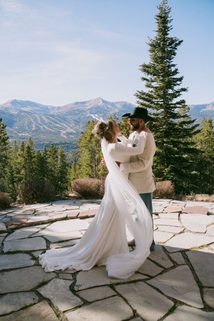 Couple embracing during an elopement in Rocky Mountain National Park with sweeping mountain views in the background
