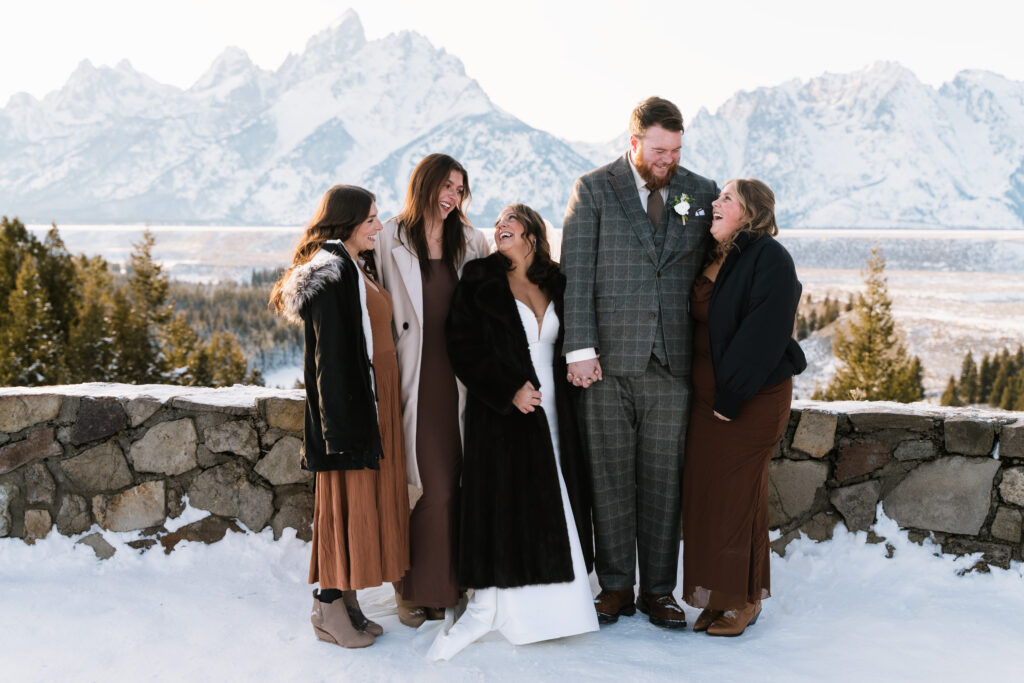couple and family at snake river overlook during a winter elopement in grand teton national park wyoming with snowy mountains and scenic views