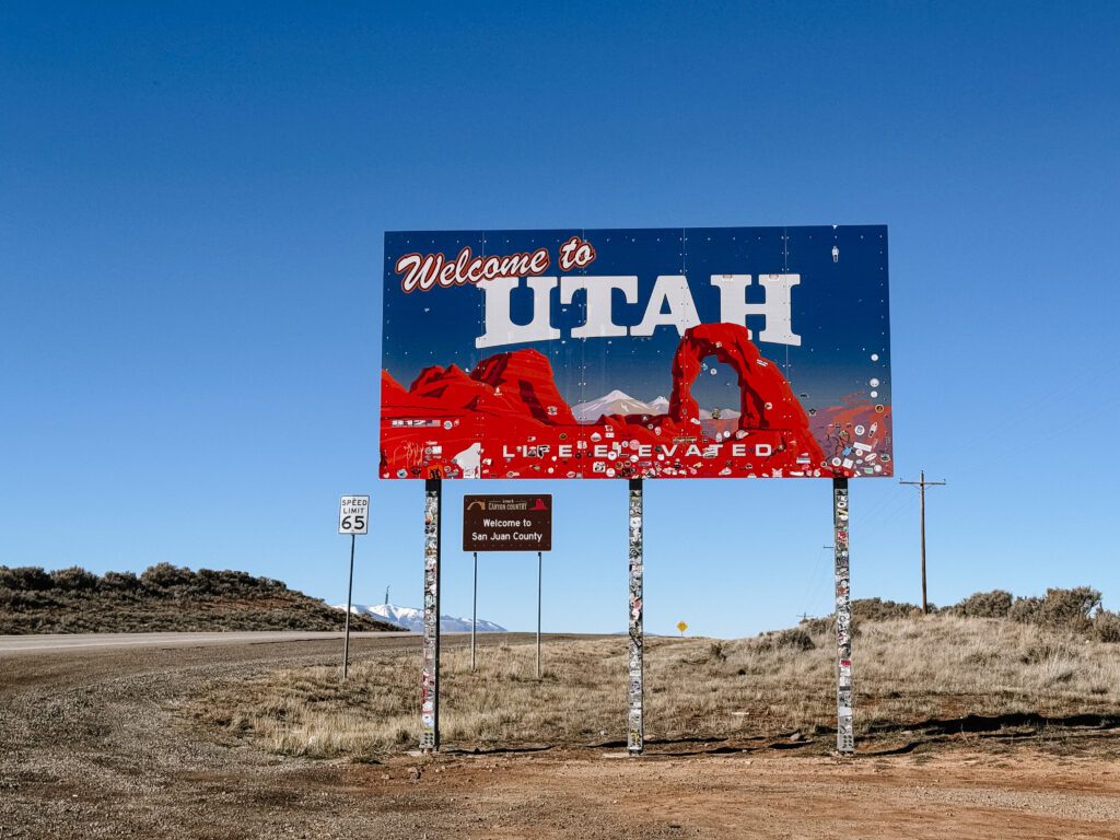 Welcome to Utah sign along the highway, representing a popular destination for elopements and adventure weddings