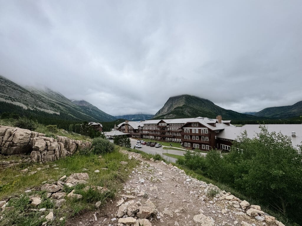 Scenic mountain view overlooking Many Glacier Hotel in Glacier National Park featuring dramatic alpine peaks, historic lodge, and breathtaking ceremony views for adventurous Montana elopements